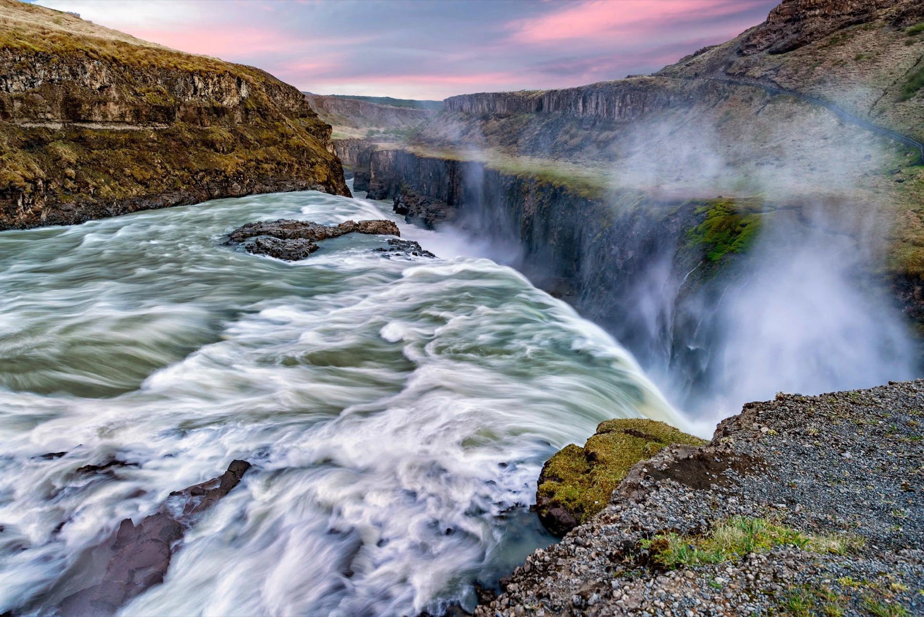 Gullfoss waterfall surging through a rocky gorge in bright mist